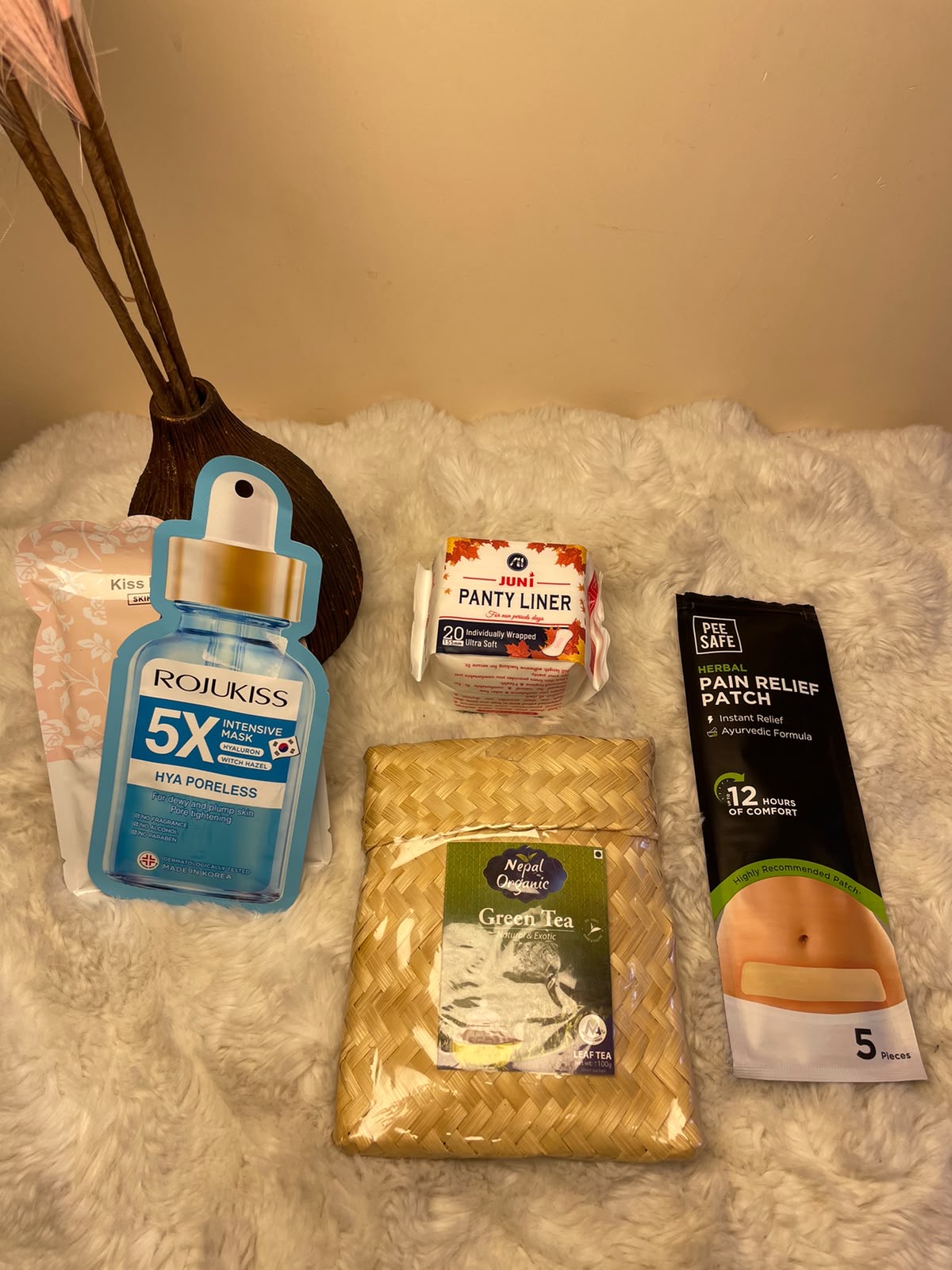 Relaxation Care Kit A simple self-care combination featuring two skincare face masks, a panty liner, pain relief patch, and green tea.