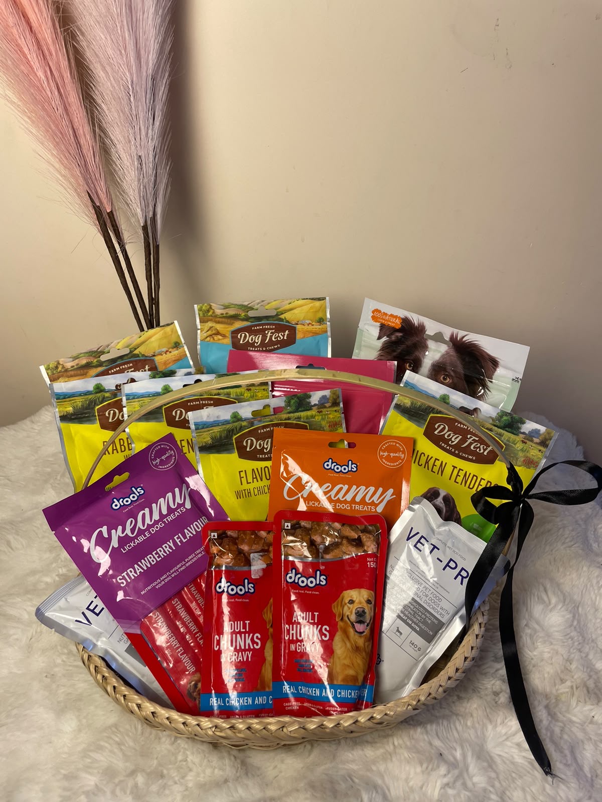 A thoughtfully curated gift basket filled with a variety of dog food and tasty pet snacks in different flavors. Designed for pet lovers, this hamper offers a fun and convenient way to treat their furry companions with a selection of delicious options.