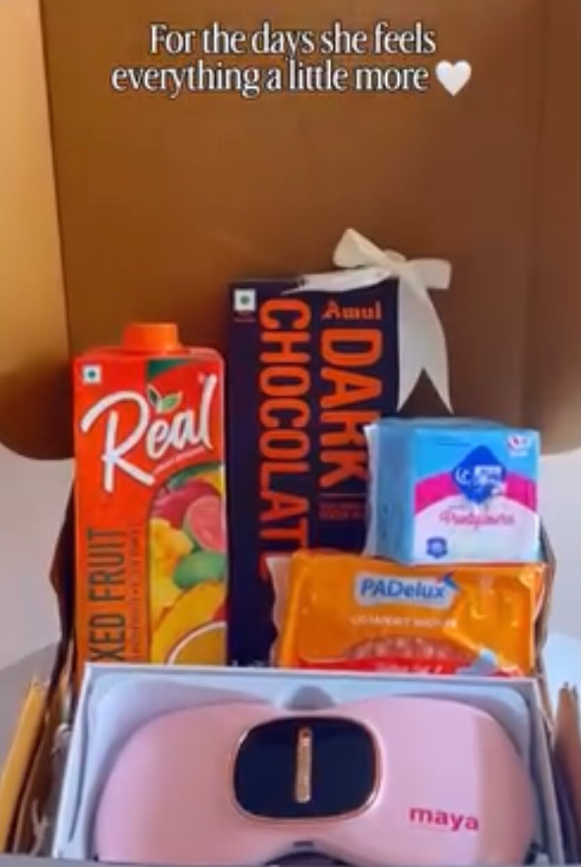 A thoughtful period-care hamper bringing together refreshing juice, dark chocolate, sanitary pads, pantyliners, and a period cramp belt. It combines practical essentials with comforting treats in one convenient gift set.