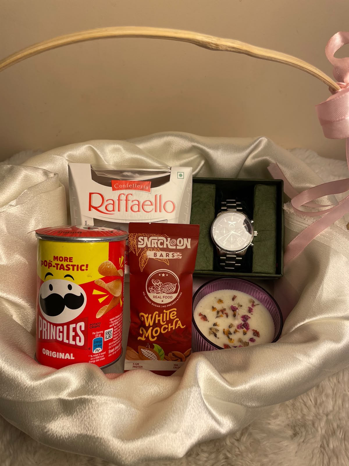 A premium corporate gift set combining snacks, chocolates, a premium watch for him, and a scented candle for a balanced festive presentation.