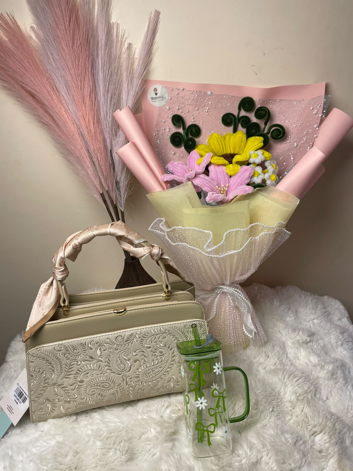 A thoughtfully curated gift combination featuring 1 classic white bag, 1 glass tumbler, and a beautiful artificial mixed bouquet of sunflower and pink flowers, presented as a stylish and practical gift set.