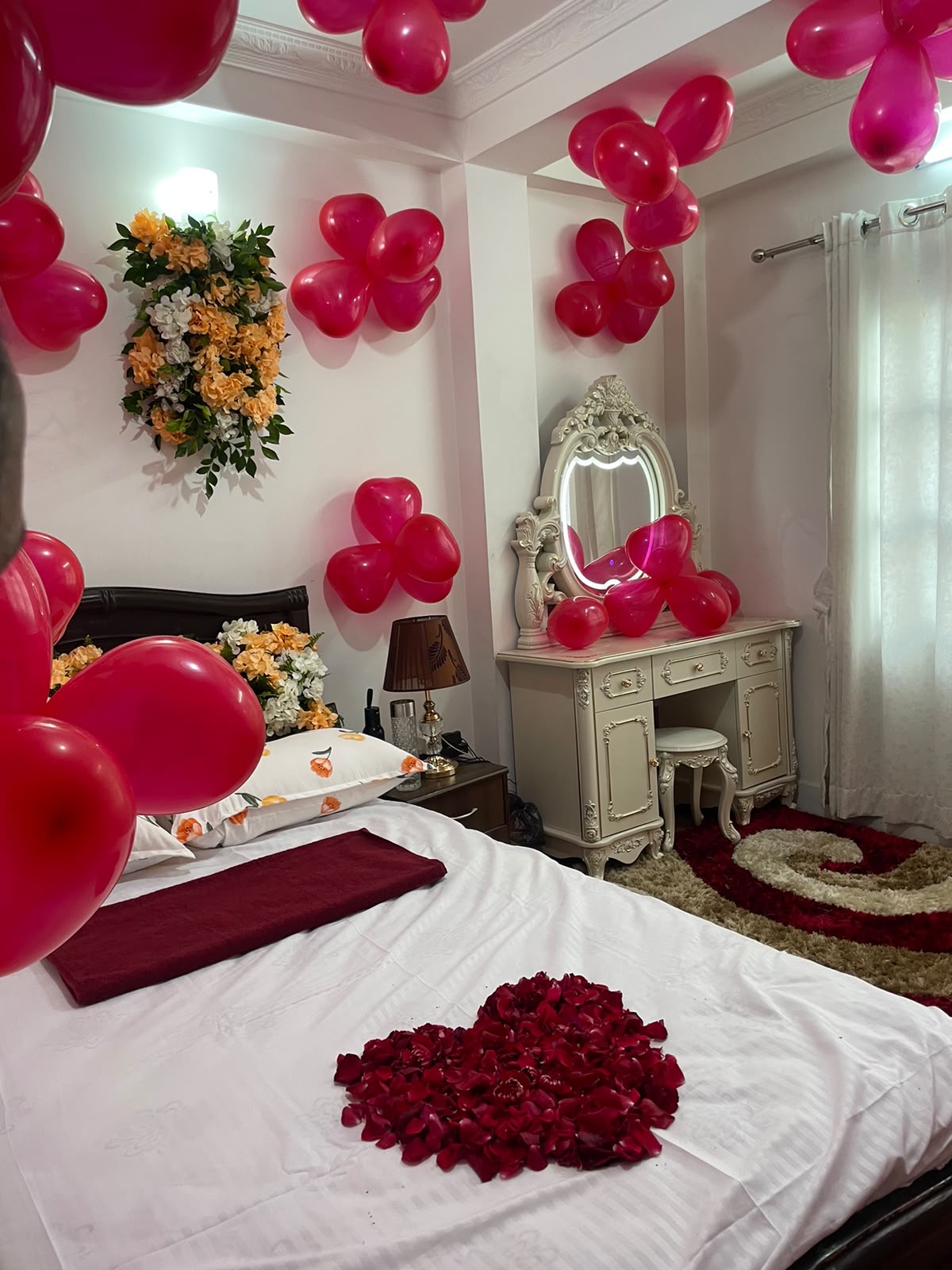 Transform a room into a festive and memorable space with colorful decorations and red balloon accents. This setup is suitable for birthdays, anniversaries, romantic surprises, and special occasions.