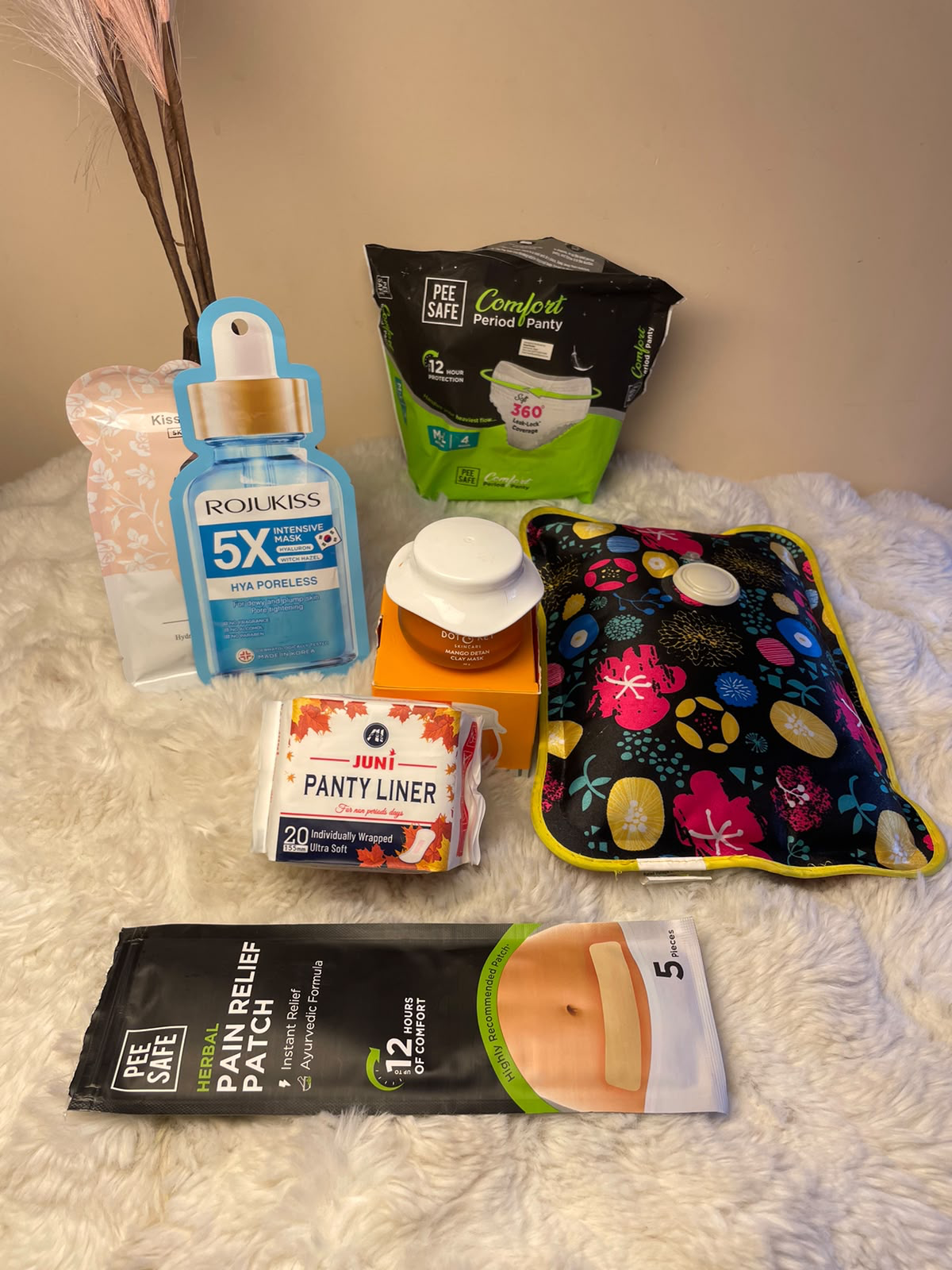 A caring and useful gift set featuring a hot bag, pain relief patch, period panty, panty liner, face masks, and clay mask. Perfect for personal self-care or as a thoughtful gift for someone who deserves a little extra comfort and care.