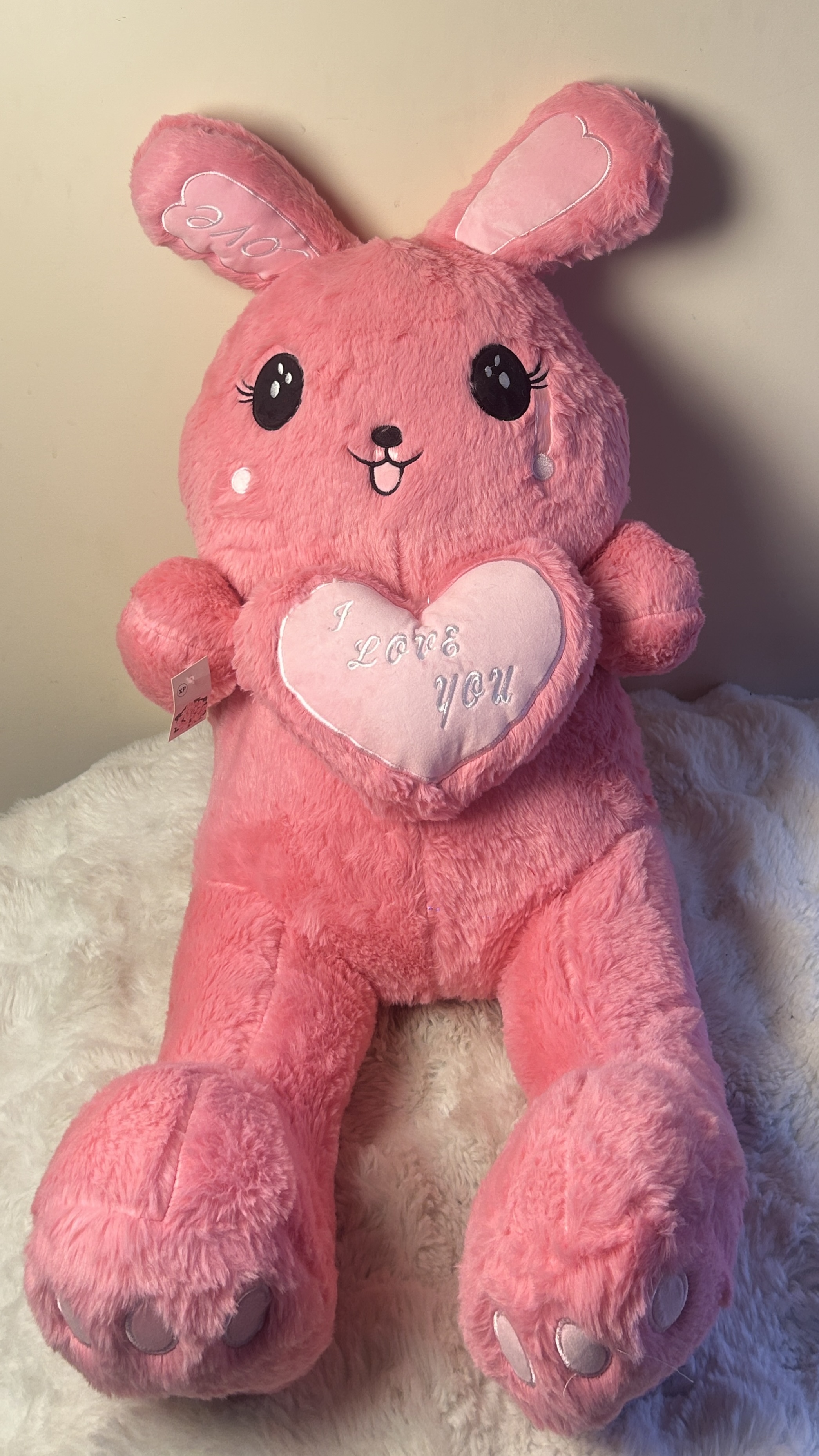 A cute pink bunny plush with long ears and a soft, cuddly design, perfect for gifting and decoration.