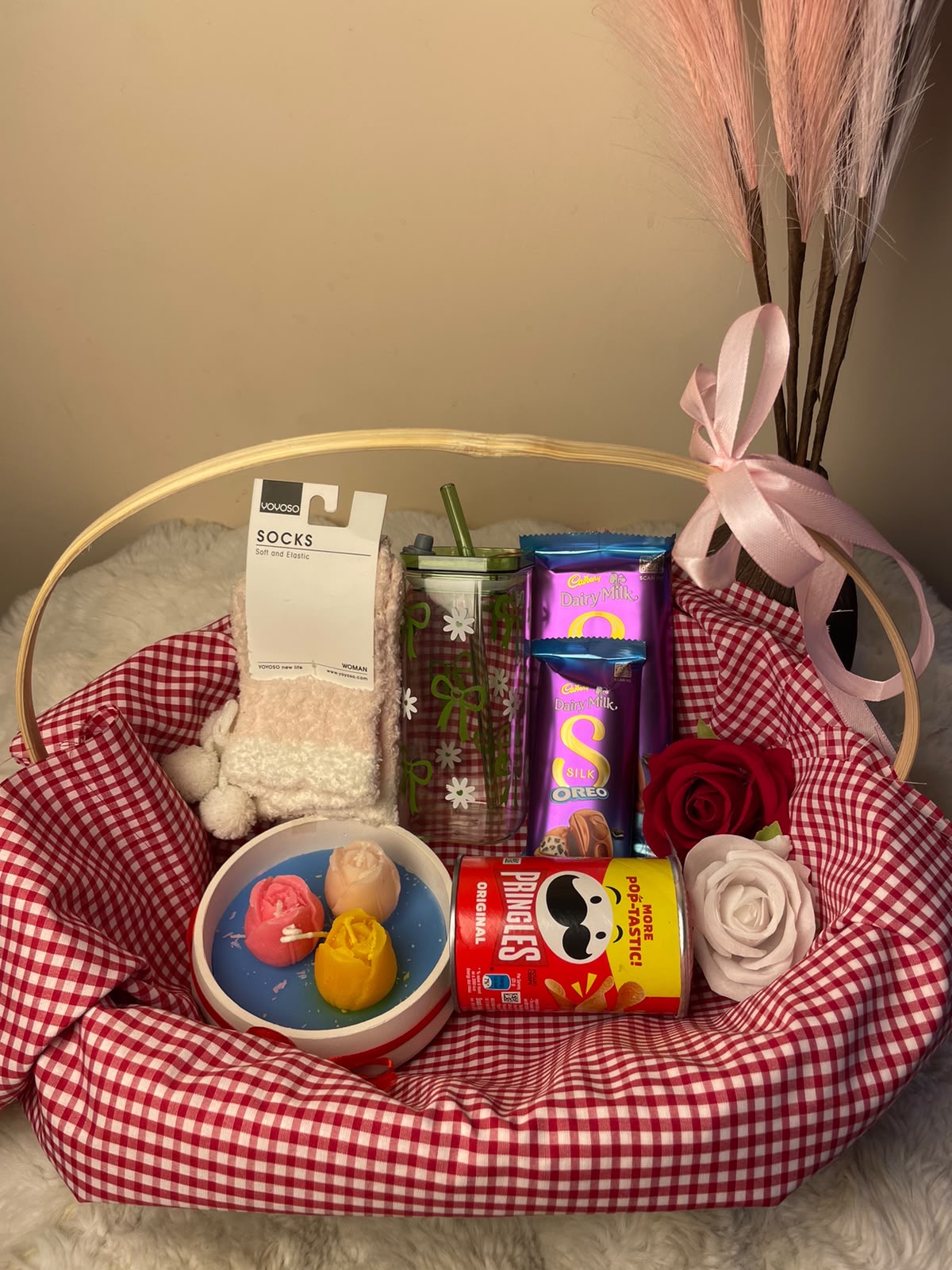 Sweetness Gift Set A cozy festive hamper combining a scented candle, cute socks, glass tumbler, mini Pringles, and Dairy Milk Silk Oreo chocolates.