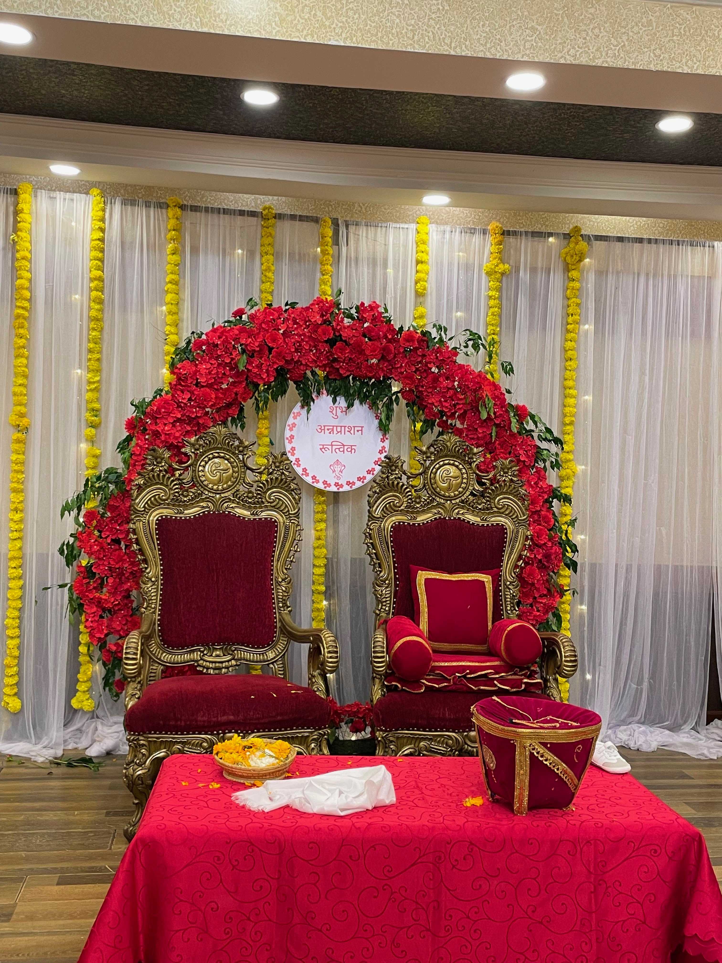 Designed for families who prefer simplicity with a touch of luxury, this Pasni decoration combines a rich red color palette with elegant styling and essential ceremonial arrangements. The setup creates a beautiful space for family blessings, traditional rituals, and memorable photographs without excessive decoration.