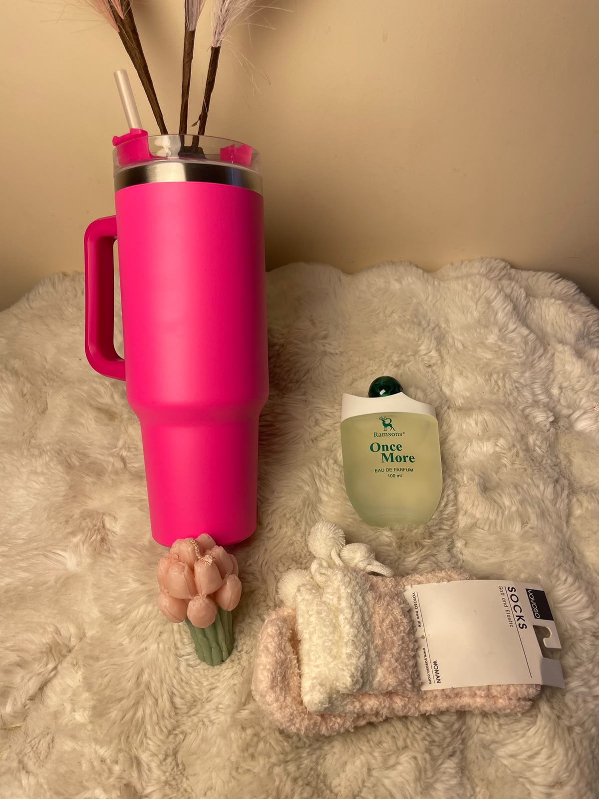 A stylish festive gift set combining a pink tumbler, floral-design scented candle, cute socks, and a perfume for him. A practical and attractive combination for corporate gifting.