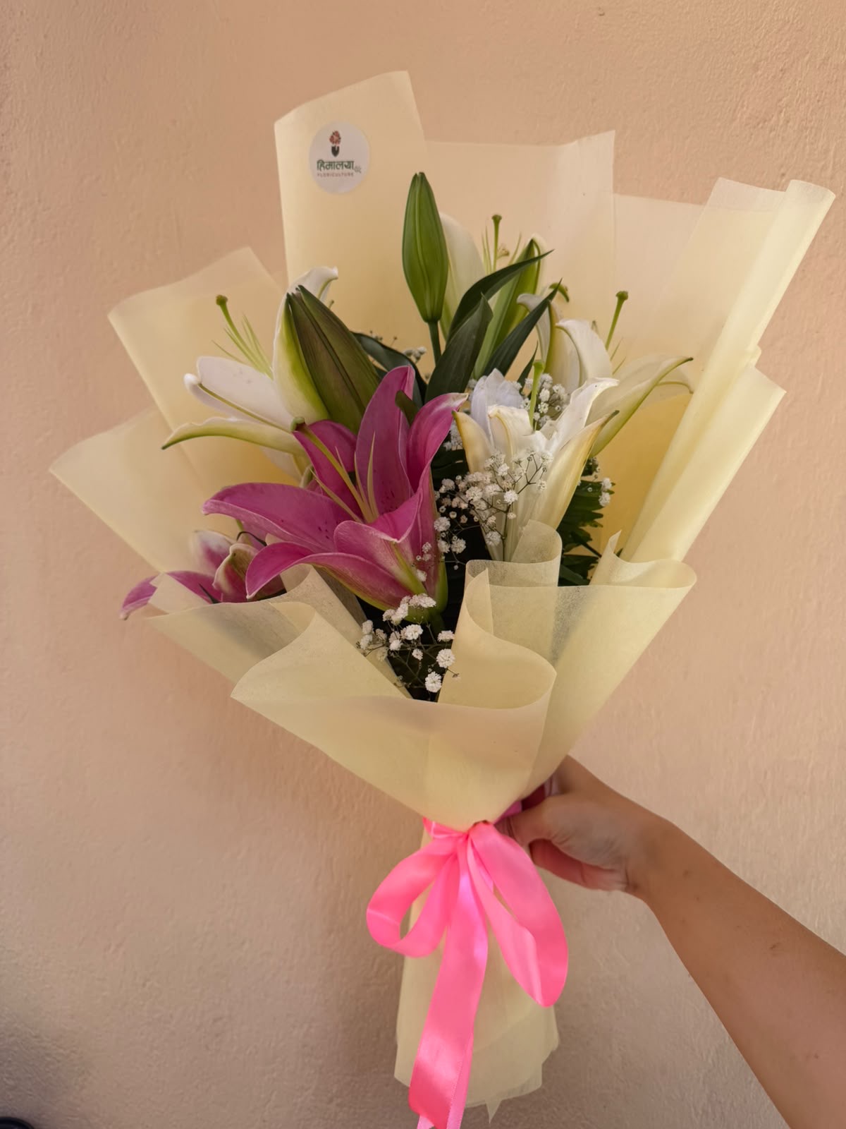 Lily Bloom A charming Lily Bouquet featuring pink and white lilies, delicate Gypsophila, and elegant butter-yellow wrapping—perfect for expressing love, appreciation, and warm wishes.