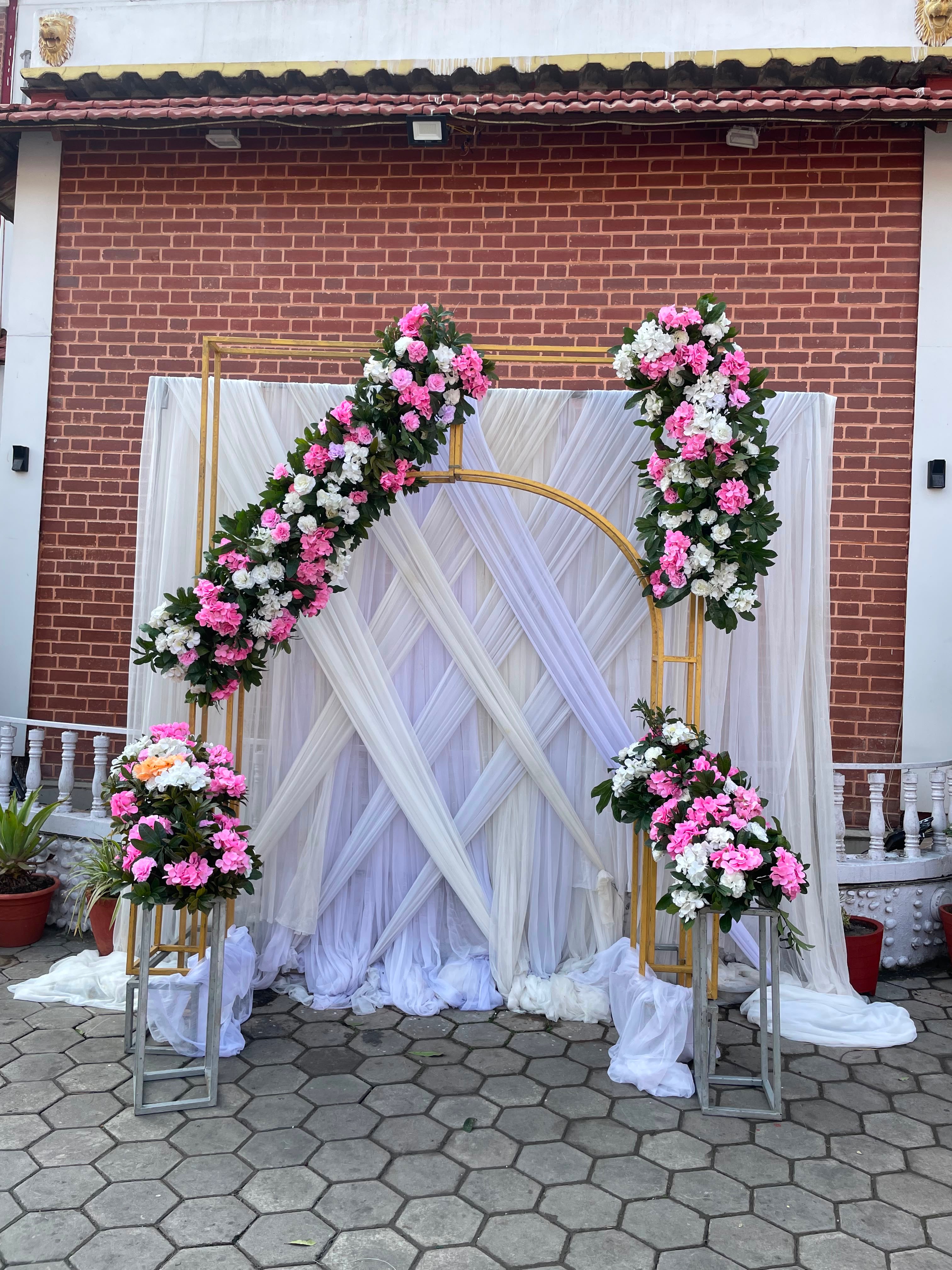 Add a graceful finishing touch to your event with a pink and white floral photobooth that blends modern styling with a soft, romantic atmosphere. The coordinated floral details create an inviting space for guests to take pictures and enjoy the celebration, while the reusable artificial flowers offer a practical decorative option.