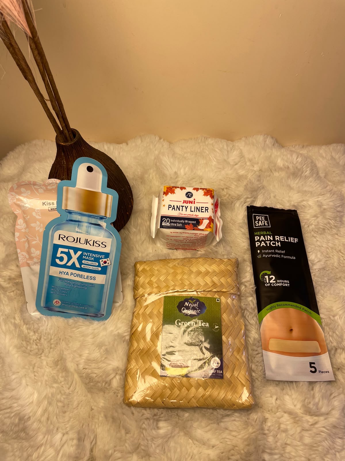 Beauty & Period Essentials A simple self-care package combining two skincare face masks with a panty liner, pain relief patch, and green tea.