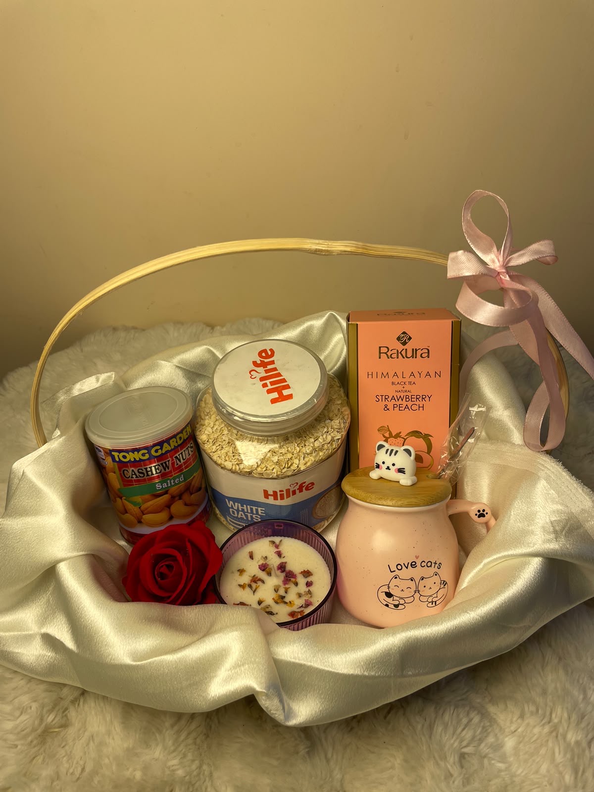 Premium Wellness Hamper A thoughtful festive hamper featuring a scented candle, ceramic cup, oats, flavored green tea, and cashew nuts.