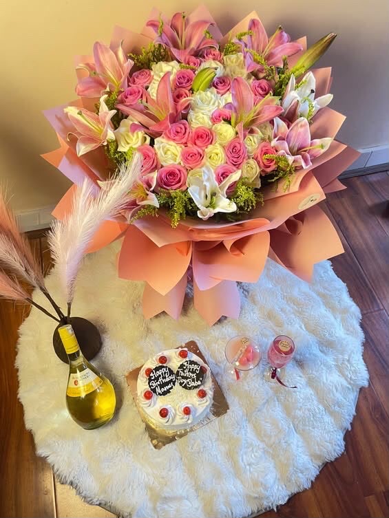 A charming pink-themed gift set combining fresh flowers, cake, wine, and scented candles—perfect for birthdays, anniversaries, romantic celebrations, and special occasions.