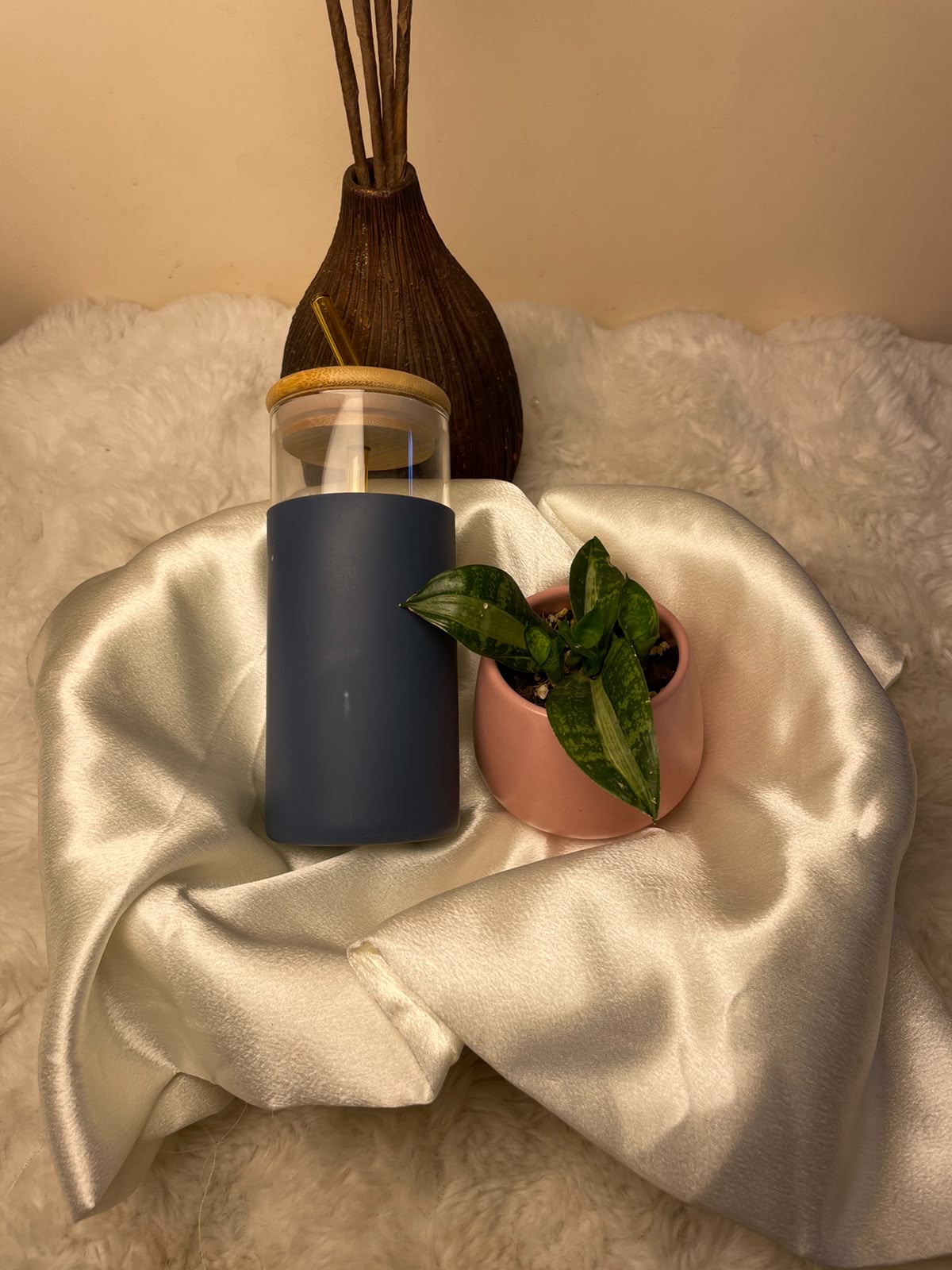 Green Lifestyle Gift Set A simple and elegant gift set pairing a glass tumbler with a green indoor plant presented in a beautiful pink ceramic pot.