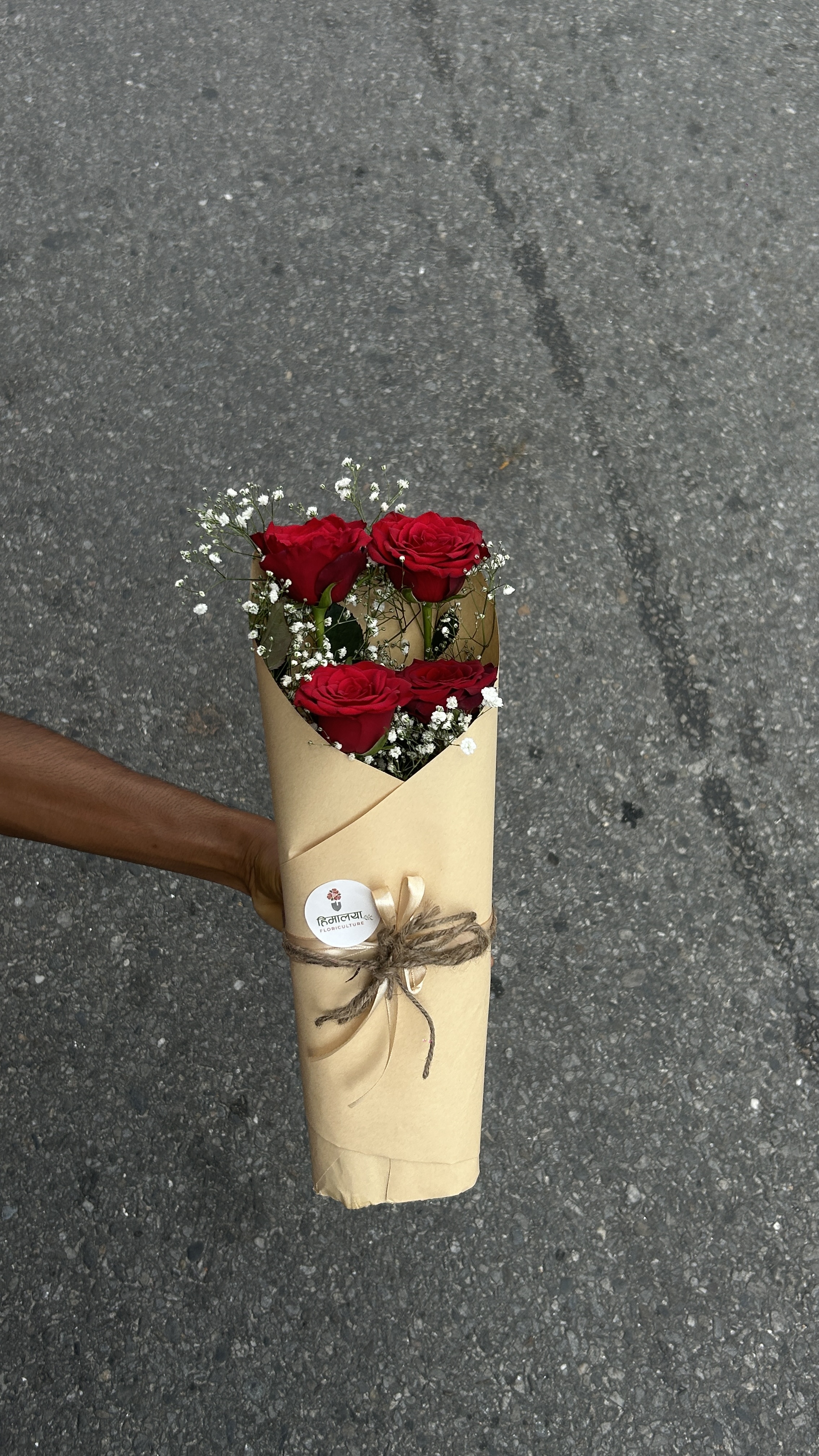 A charming arrangement featuring 4 fresh red roses, beautifully arranged on an Oasis base and finished with premium wrapping. Its compact and elegant design makes it perfect for a simple yet meaningful gesture.