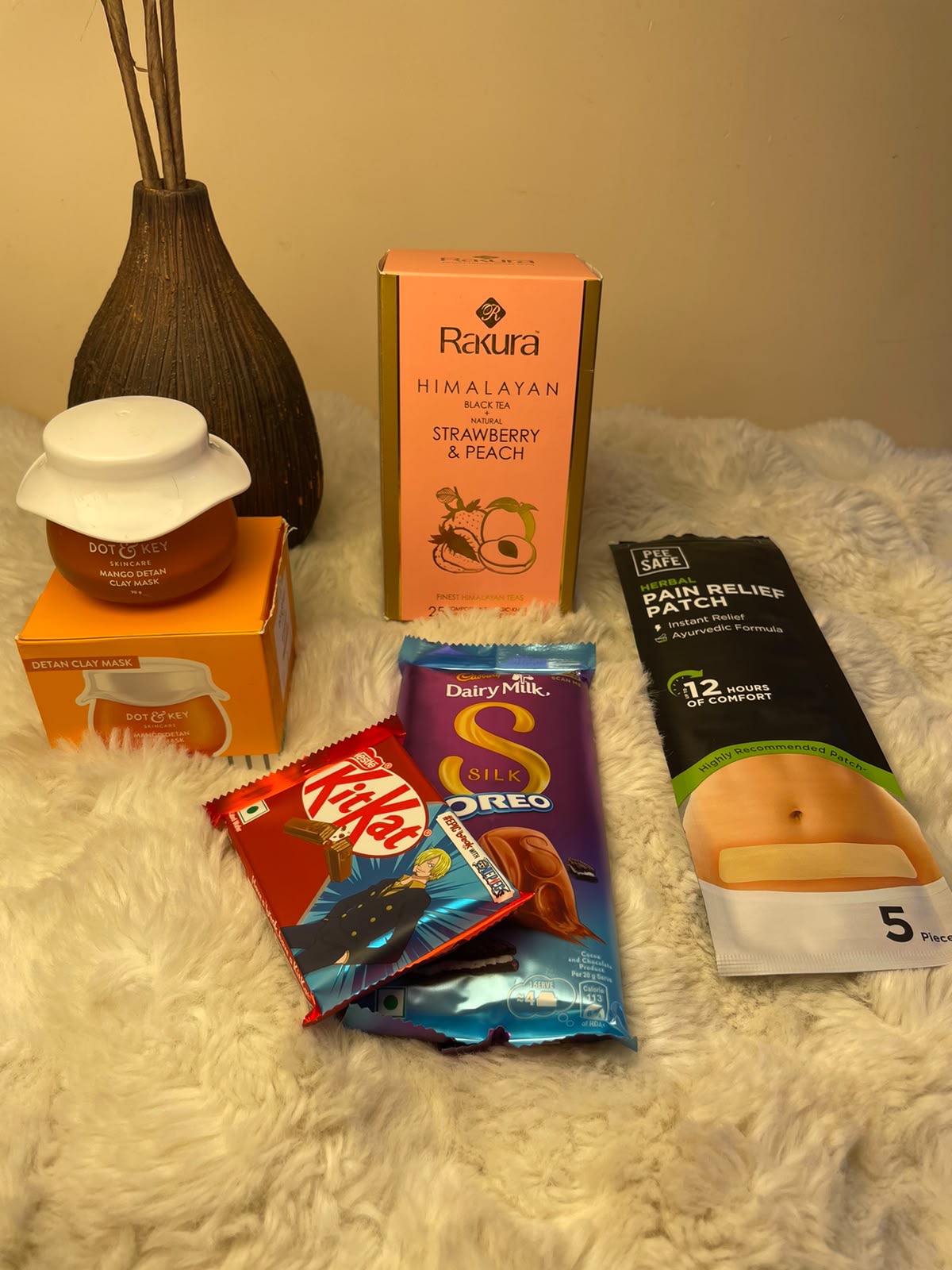 A relaxing combination of clay mask, flavored black tea, chocolate, KitKat, and a pain relief patch.