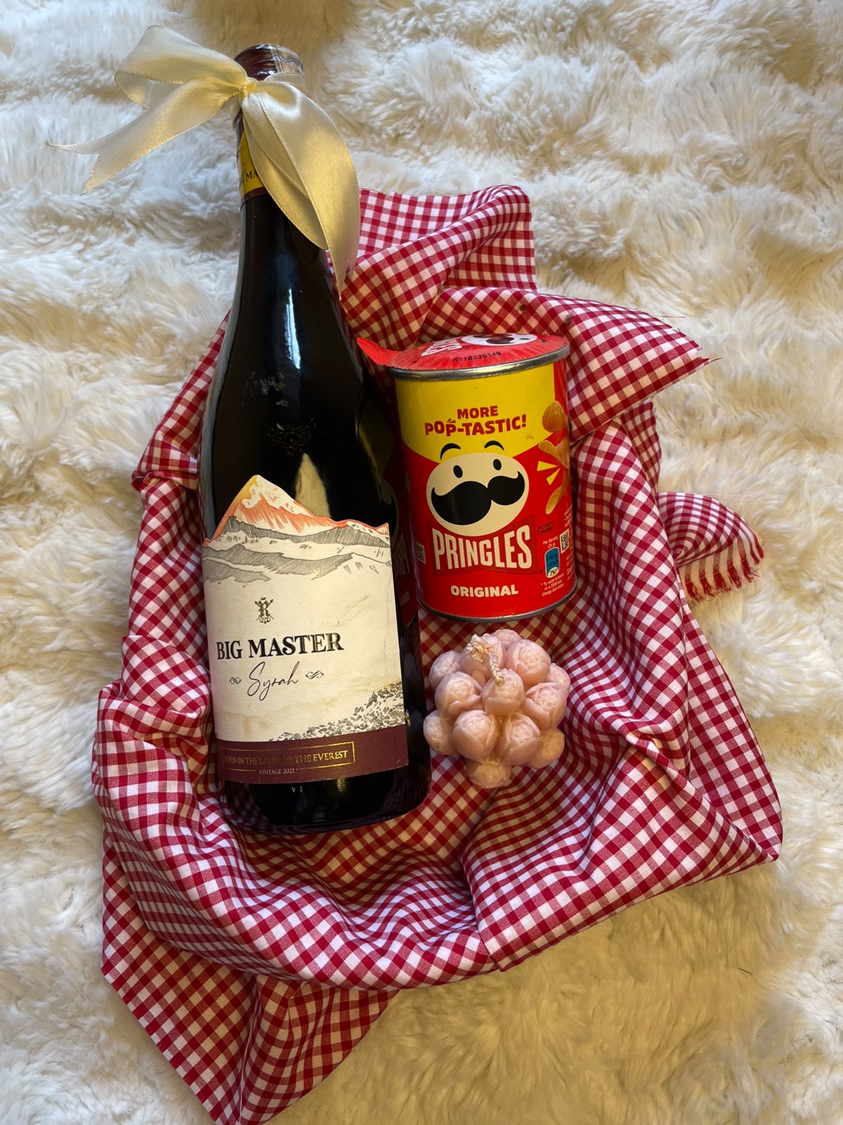 Wine Festive Hamper A stylish festive gift set combining a bottle of Big Master wine, mini flavored Pringles, and a scented candle for a celebratory presentation.