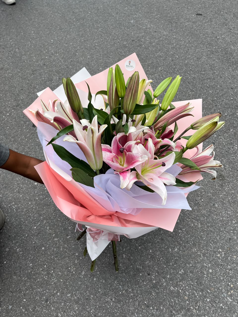As flowers are natural products, the bloom stage, flower color, and wrapping style may vary slightly based on seasonal availability while maintaining the same freshness and elegant presentation. Lilies may arrive in partially closed buds to ensure longer-lasting freshness after delivery.