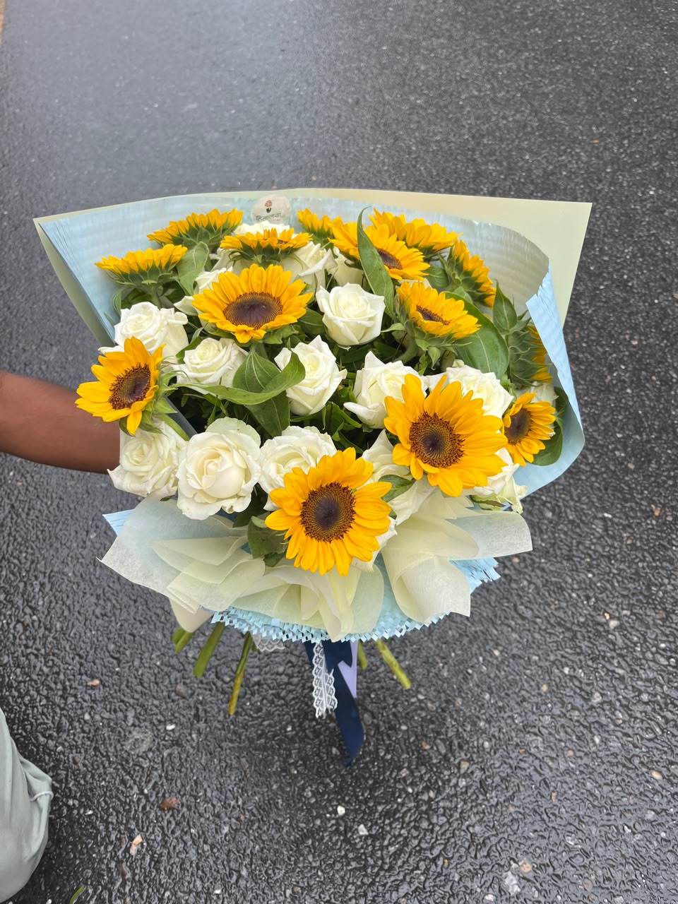 Garden Fresh Sunflower & Roses Bloom size, flower shades, and wrapping may vary slightly depending on seasonal availability while maintaining the bouquet's overall style, quality, and value.