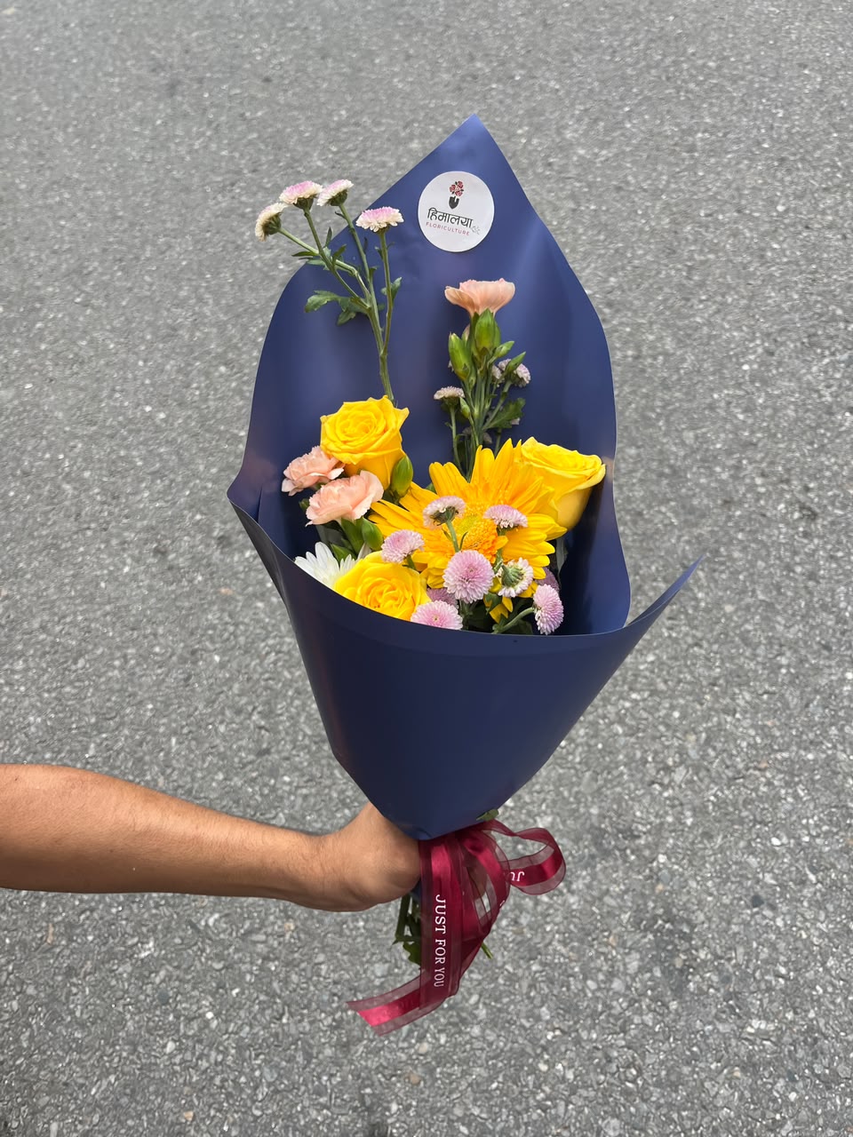 Flowers are natural products, so slight variations in color, bloom size, and arrangement may occur. Spray carnations may be replaced with regular carnations based on seasonal availability while maintaining the bouquet's overall look and quality. Wrapping paper, ribbons, greenery, and fillers may be substituted with similar premium materials based on availability.