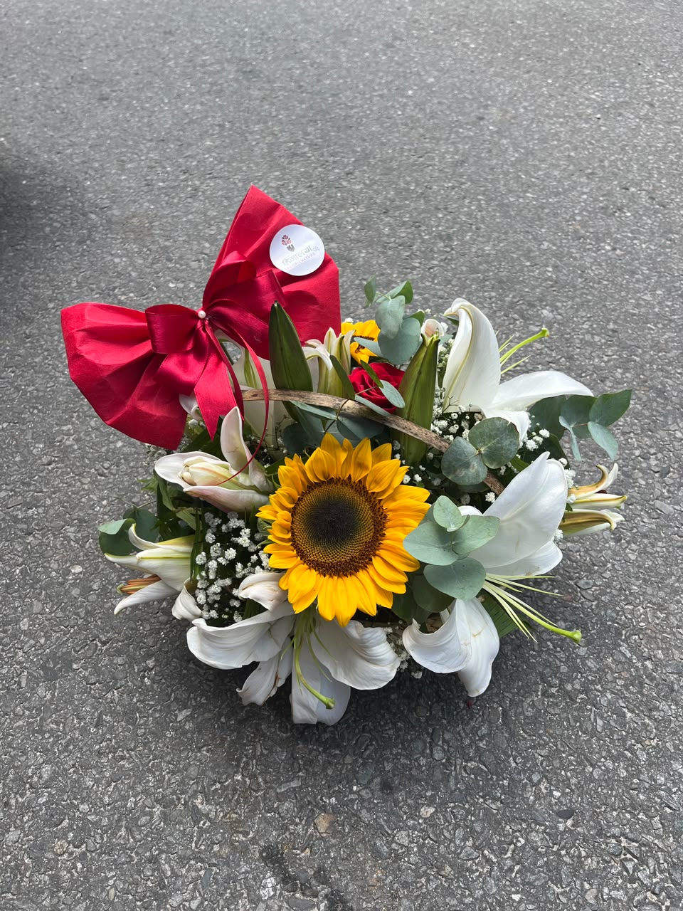 Cheerful Sunflower and Lily Basket Flowers are natural products, so slight variations in color, bloom size, and arrangement may occur. Lily blooms may arrive in bud form to ensure freshness and longer vase life. Basket design, greenery, and fillers may be substituted with similar premium materials based on seasonal availability while maintaining the overall design and quality of the arrangement.