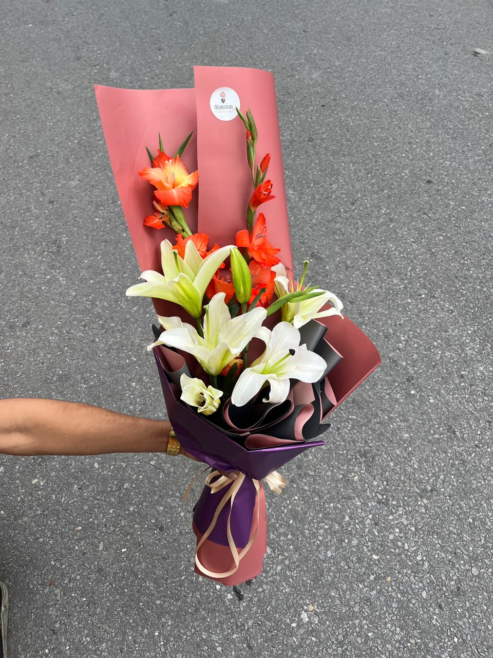 Lily & Gladiolus Bouquet Flower colours, varieties, size, shape, and bloom stage may vary slightly due to natural characteristics and seasonal availability. Wrapping, greenery, and filler flowers may also vary while maintaining the overall design, quality, and value of the bouquet.