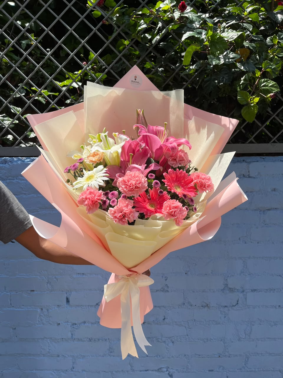 The mix of carnations, gerberas, and daisies may vary depending on seasonal availability and stock. Flower varieties, colors, wrapping materials, ribbons, and decorative elements may be replaced with similar alternatives while maintaining the overall look and value of the bouquet. Customization is available according to preference and budget.