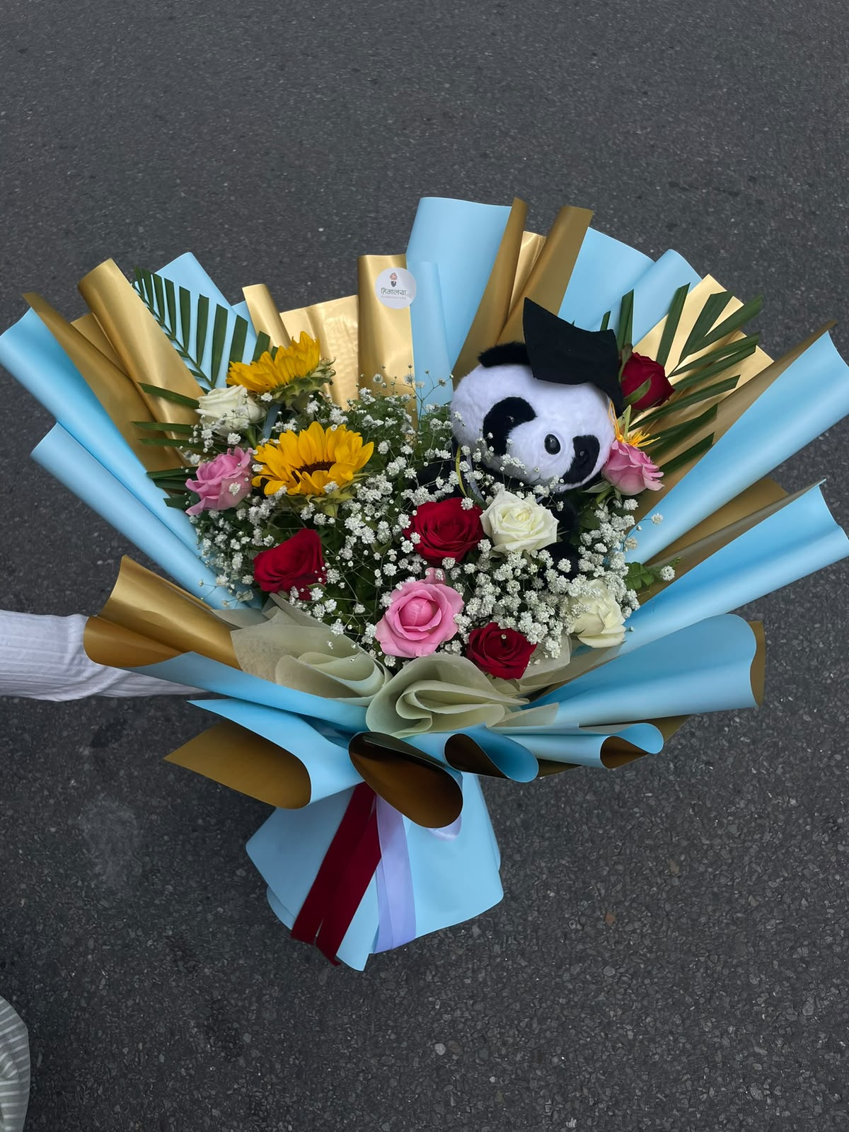 12-Stem Teddy Bloom Flower colours and teddy design may vary slightly depending on availability. The bouquet will be arranged to maintain a similar overall look and value.