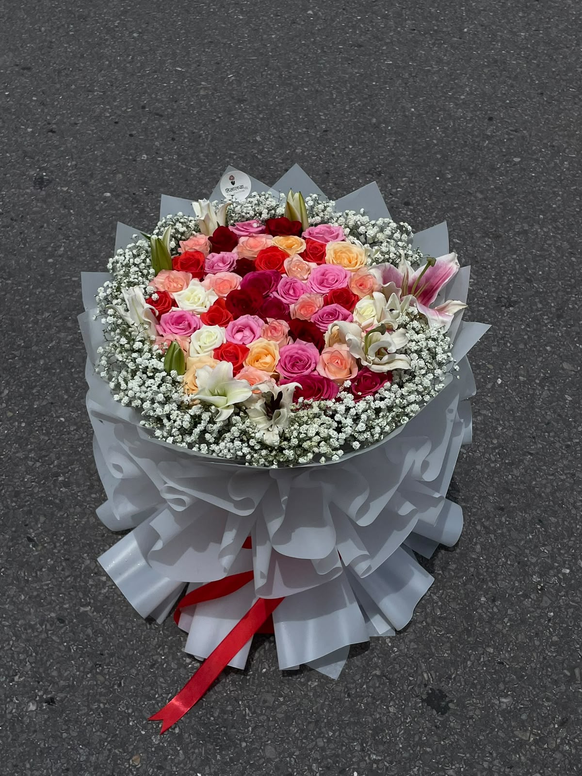 40 Mixed Roses, 2 Lilies & Baby’s Breath Flower colors, varieties, and availability may vary slightly depending on seasonal availability. The bouquet will be arranged to maintain the overall look, color variety, size, and value shown. As flowers are natural products, minor variations in size, shape, and bloom stage are normal. Premium wrapping design may also vary based on availability.
