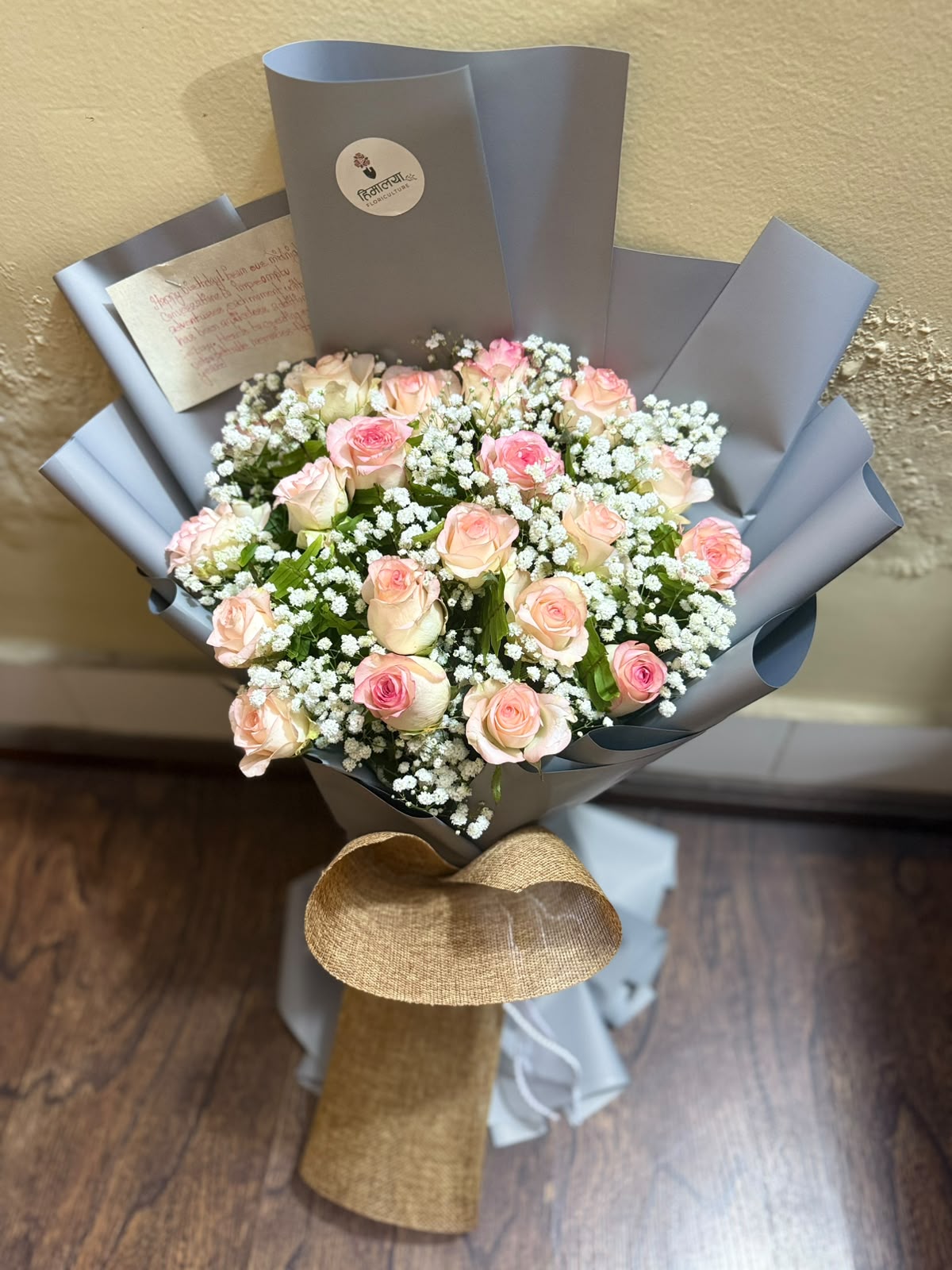 18 Pink Roses Bouquet Rose color, size, bloom stage, and gypsophila quantity may vary slightly depending on seasonal availability. As flowers are natural products, minor variations in shape, size, and appearance are normal. The bouquet will be arranged to maintain the overall look, fullness, quality, and value shown. Premium wrapping style and decorative elements may vary depending on availability.
