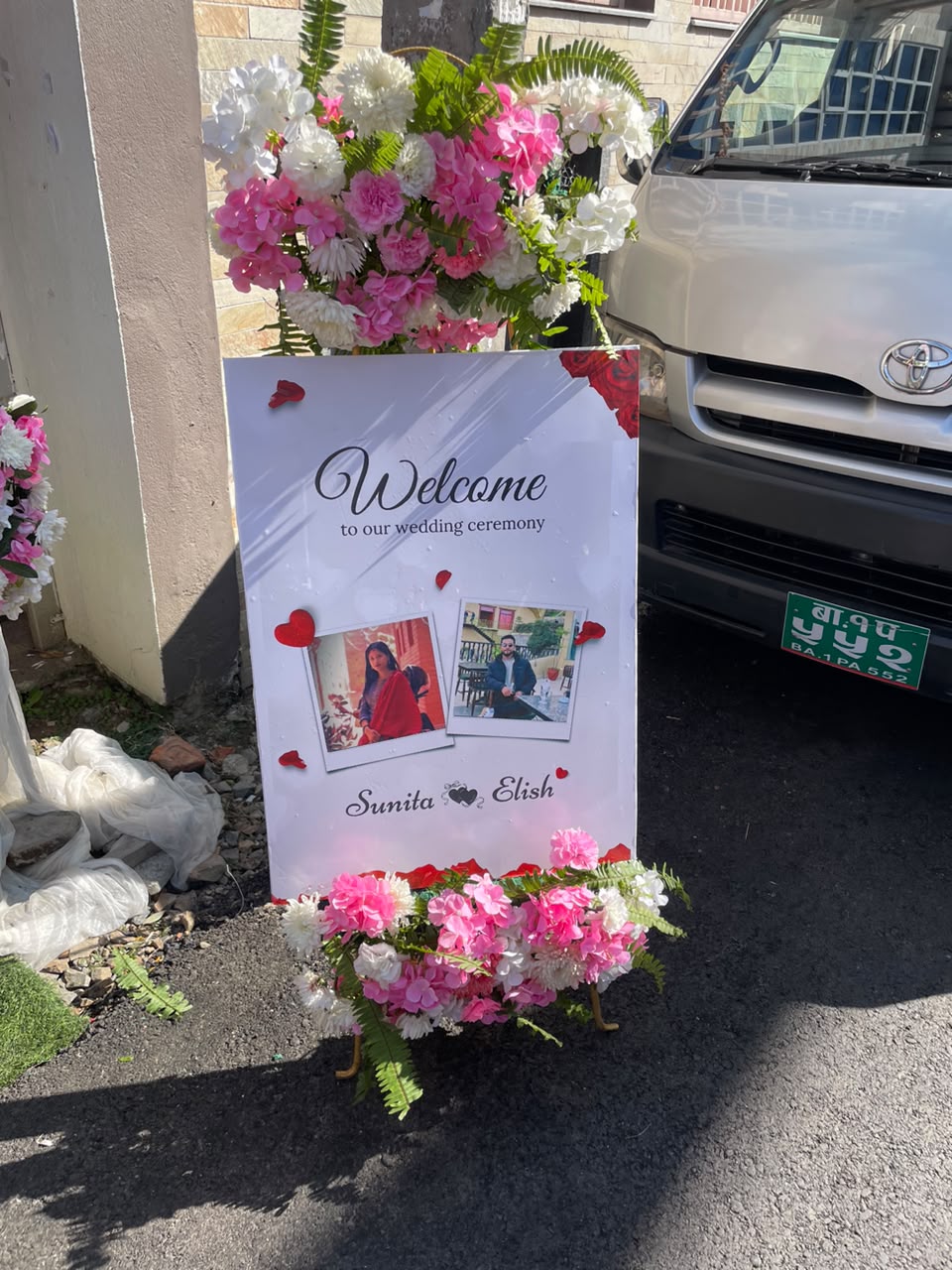 This welcome board setup instantly elevates your event entrance, creating an inviting and luxurious atmosphere the moment guests arrive. The vibrant pink floral arrangements provide a striking pop of color that sets a romantic, festive tone while doubling as a stylish backdrop for arrival photos and personalized event branding.