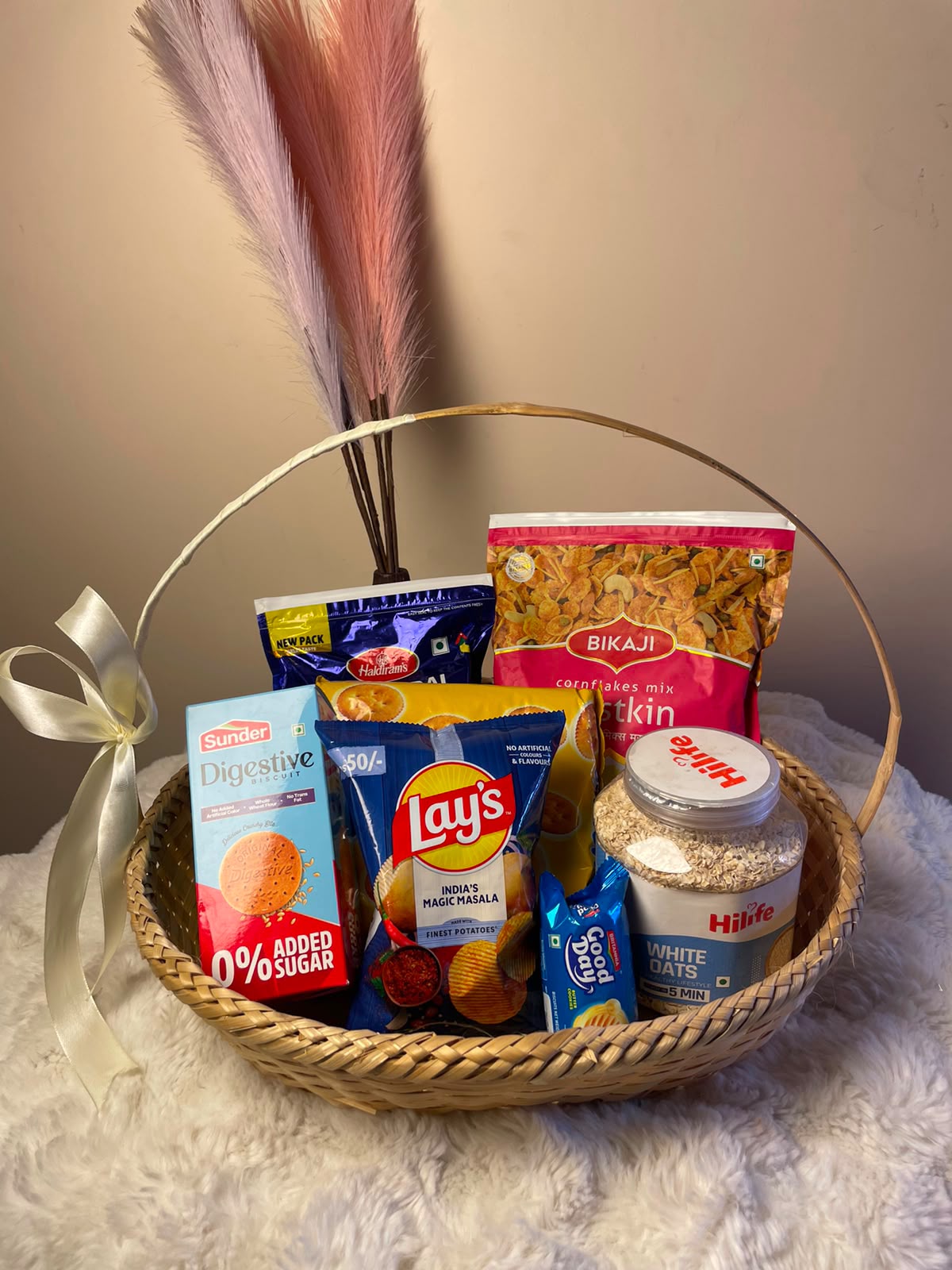 Snacks Gift Basket Product images are for representation purposes only. Actual product colour, design, size, packaging, flavour, and variant may vary depending on availability. Food products should be checked for ingredients, allergens, expiry dates, and storage instructions before consumption. If any listed item is unavailable, it may be replaced with a similar product of equal or comparable value.