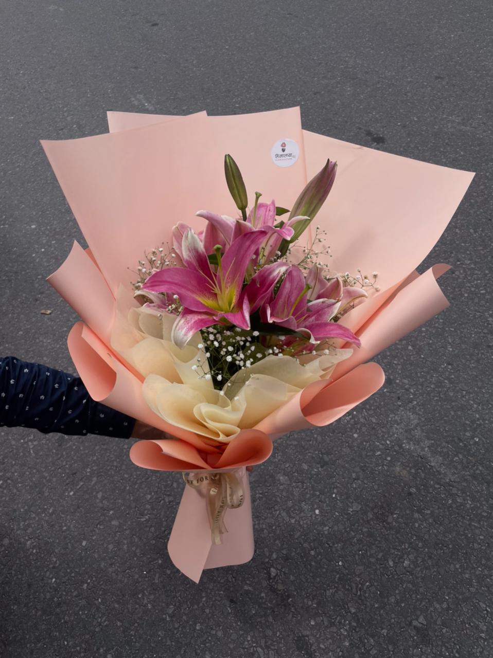 The combination of delicate pink lilies and premium pink wrapping creates a charming gift that feels thoughtful without being overly extravagant.